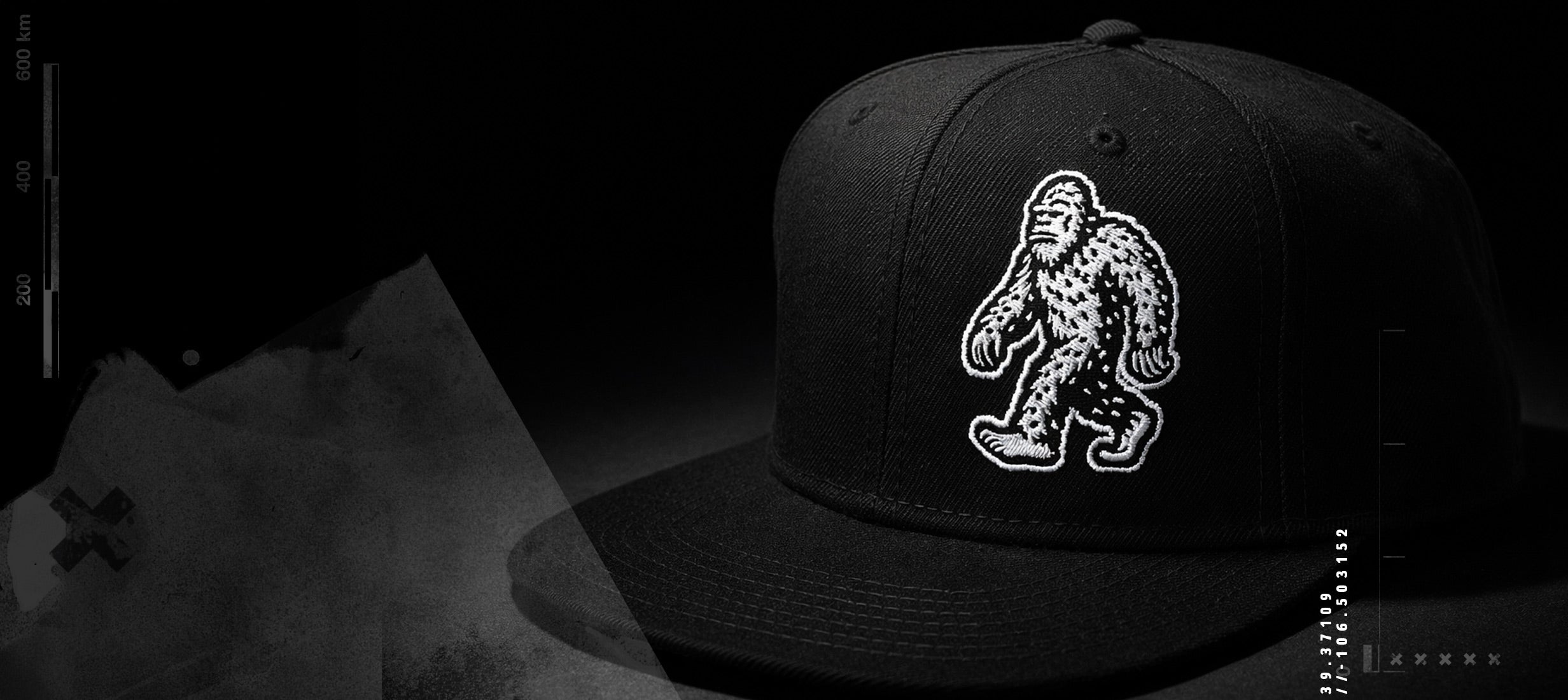 Black cap with white Bigfoot logo on a dark background