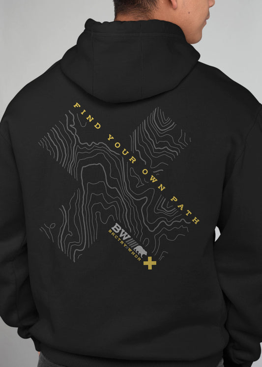 Guy wearing a black hoodie facing away from camera. The back of the hoodies has a topo map design and the words Find Your Own Path.